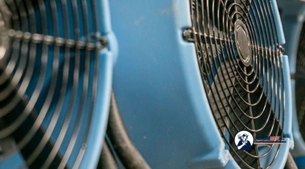 Close-up of blue industrial air movers used for structural drying after water damage.